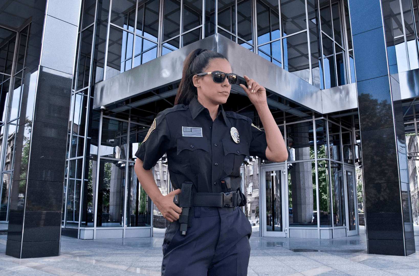 A modern office building with visible security measures, including surveillance cameras, access control systems, and security personnel, ensuring asset protection and workplace safety.
