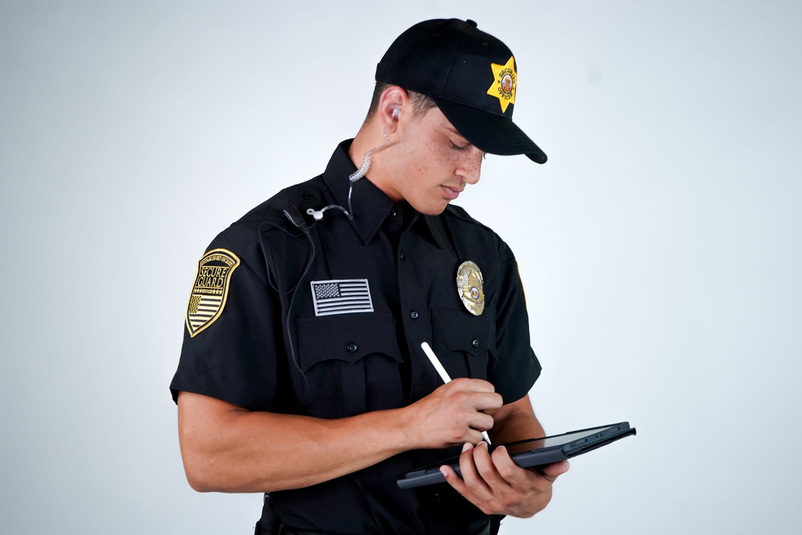 A professional security guard in uniform carefully documenting an incident report, ensuring accurate and detailed records for safety and legal compliance.