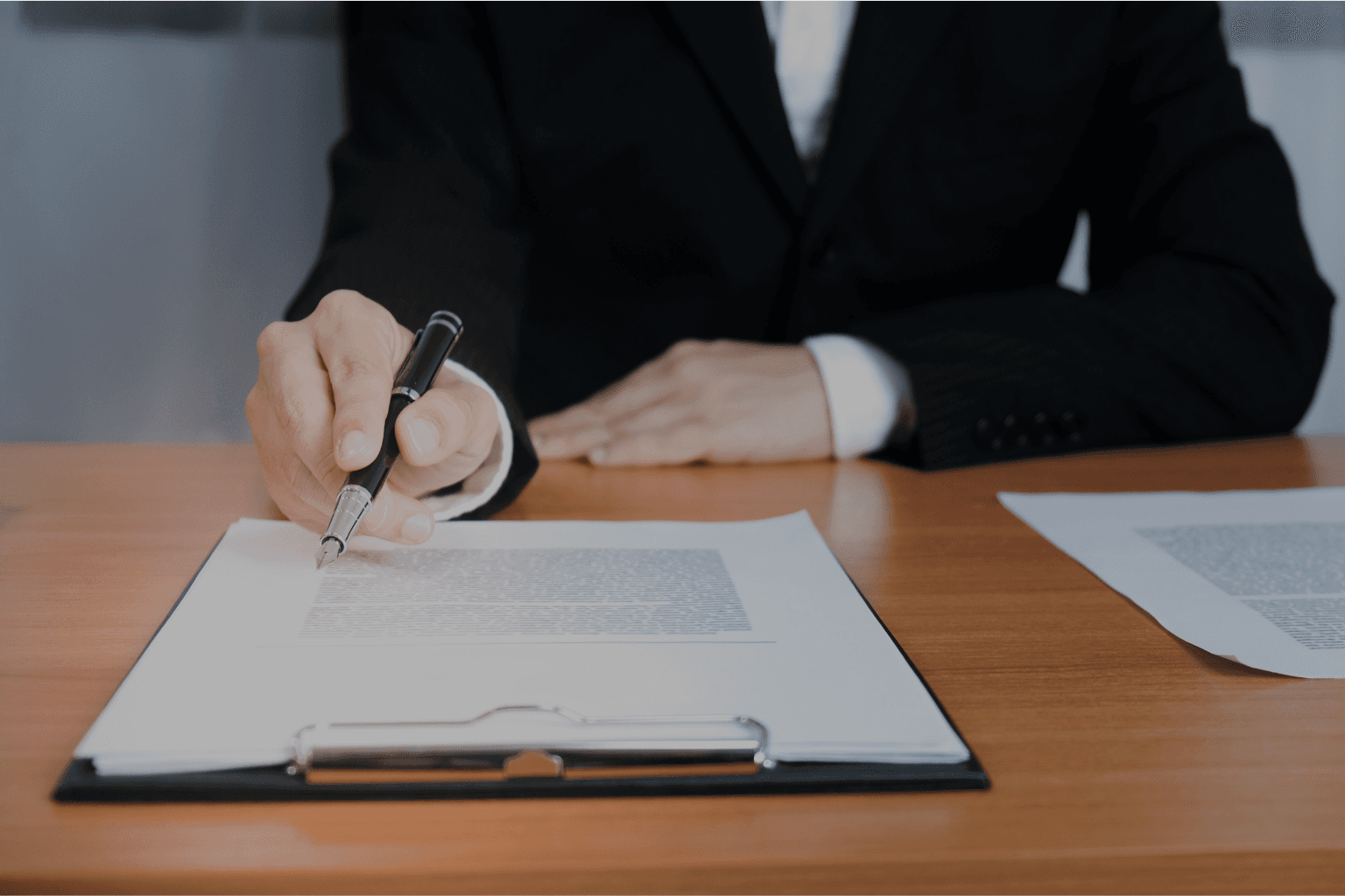Business professional reviewing and pointing to details in a security service contract, highlighting the importance of understanding quotes before signing.
