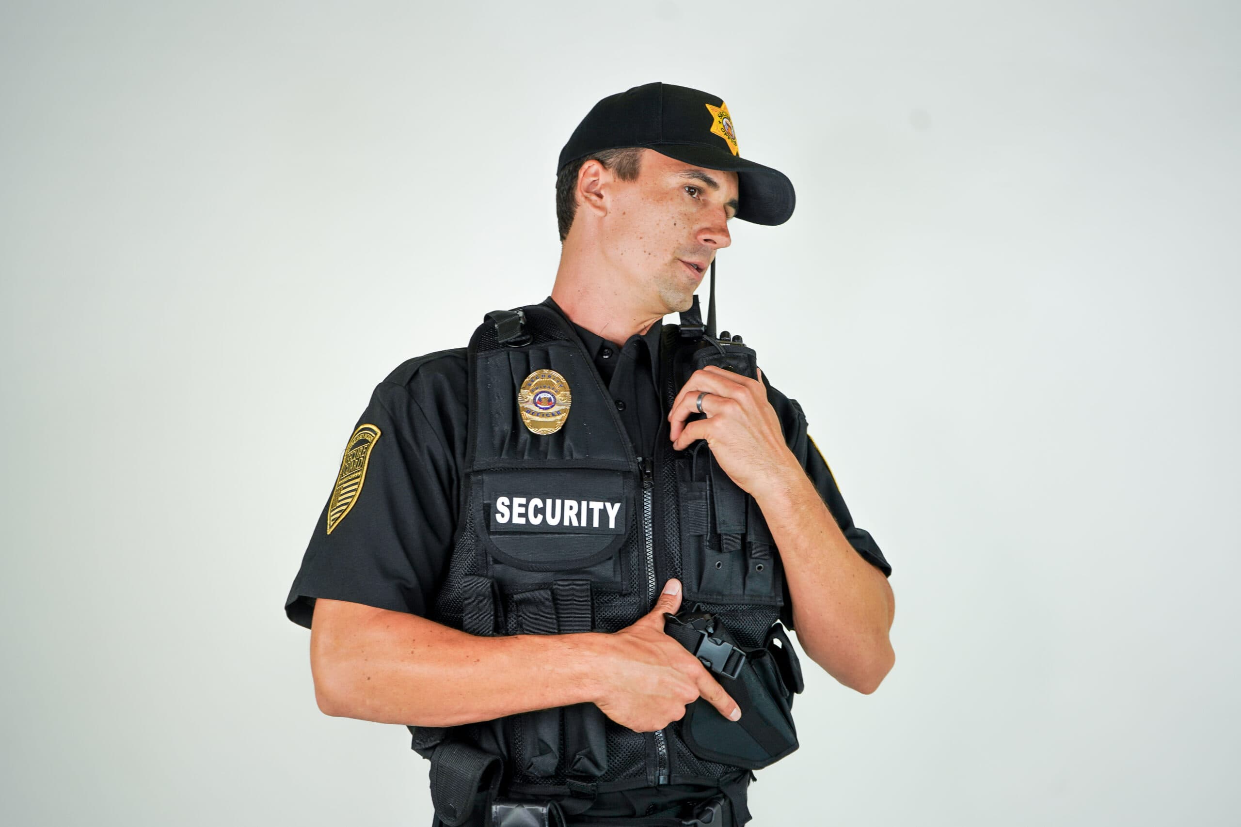 Armed security guard in uniform communicating via radio for enhanced protection in Sacramento.