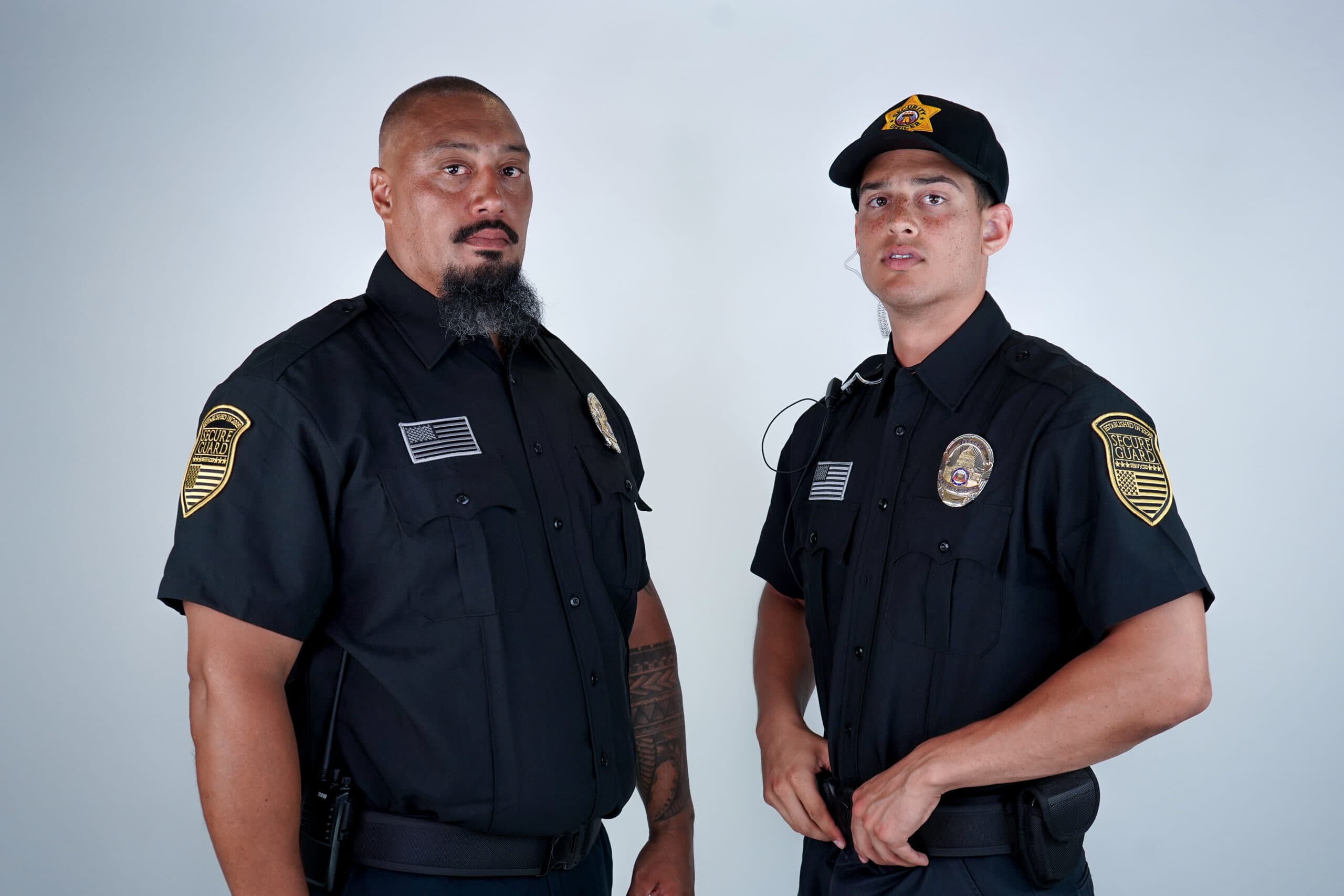 Two uniformed security guards standing confidently, representing professional security guard training and certification requirements in California.