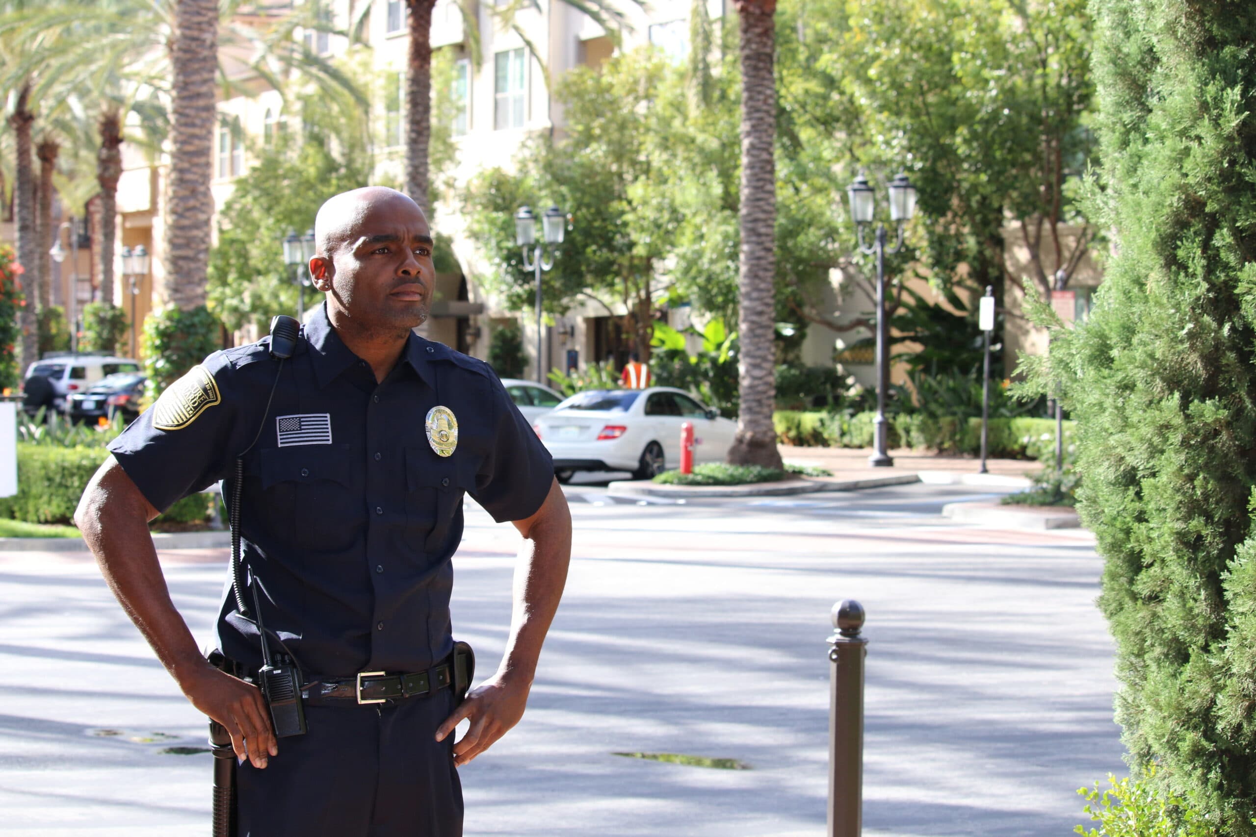 Retail security guard standing alert outside a retail center in San Francisco, providing visible deterrence to shoplifting and ensuring shopper safety.