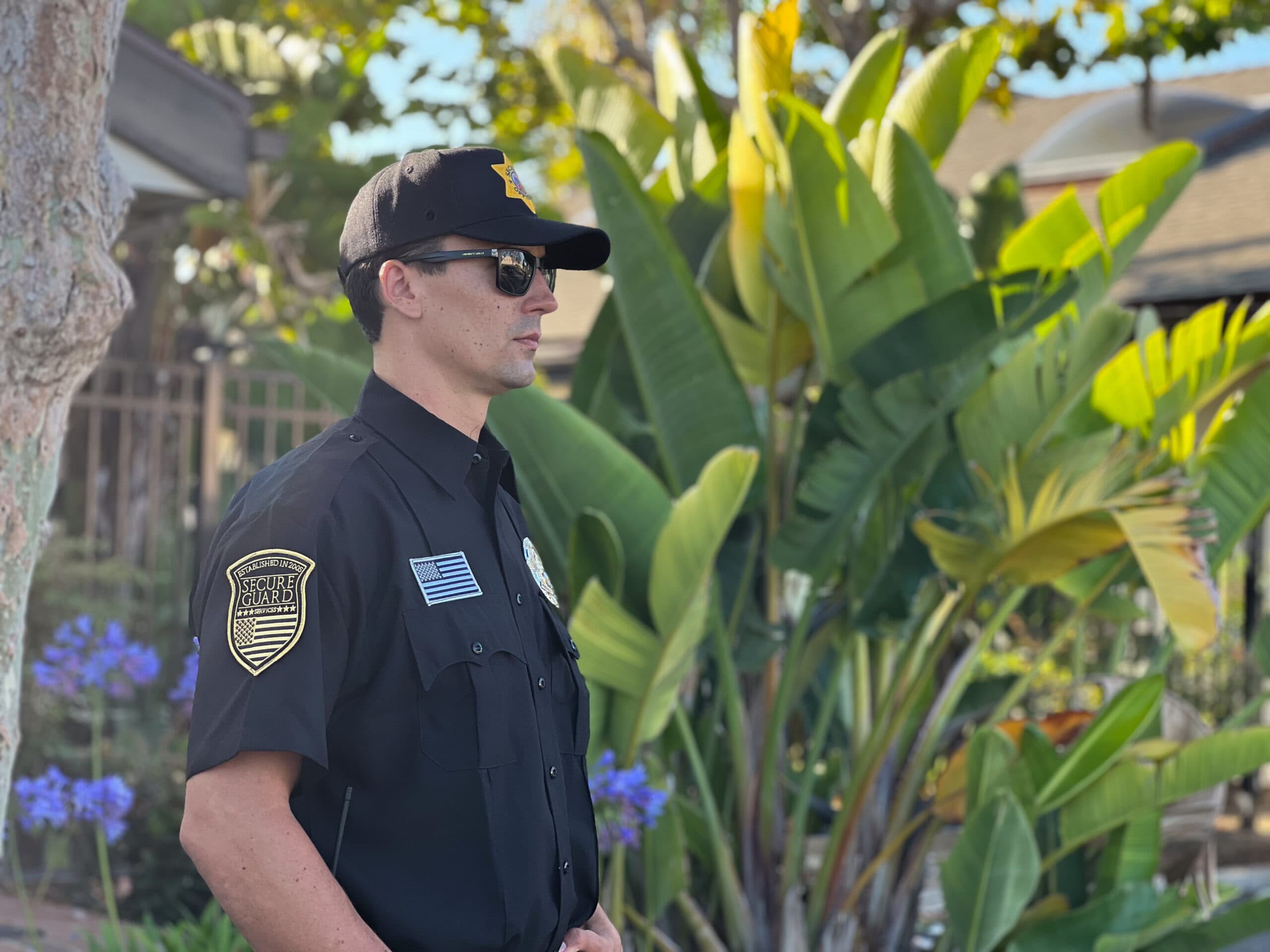 Armed security guard on patrol protecting a residential property, demonstrating professional armed security services for high-risk sites in Los Angeles