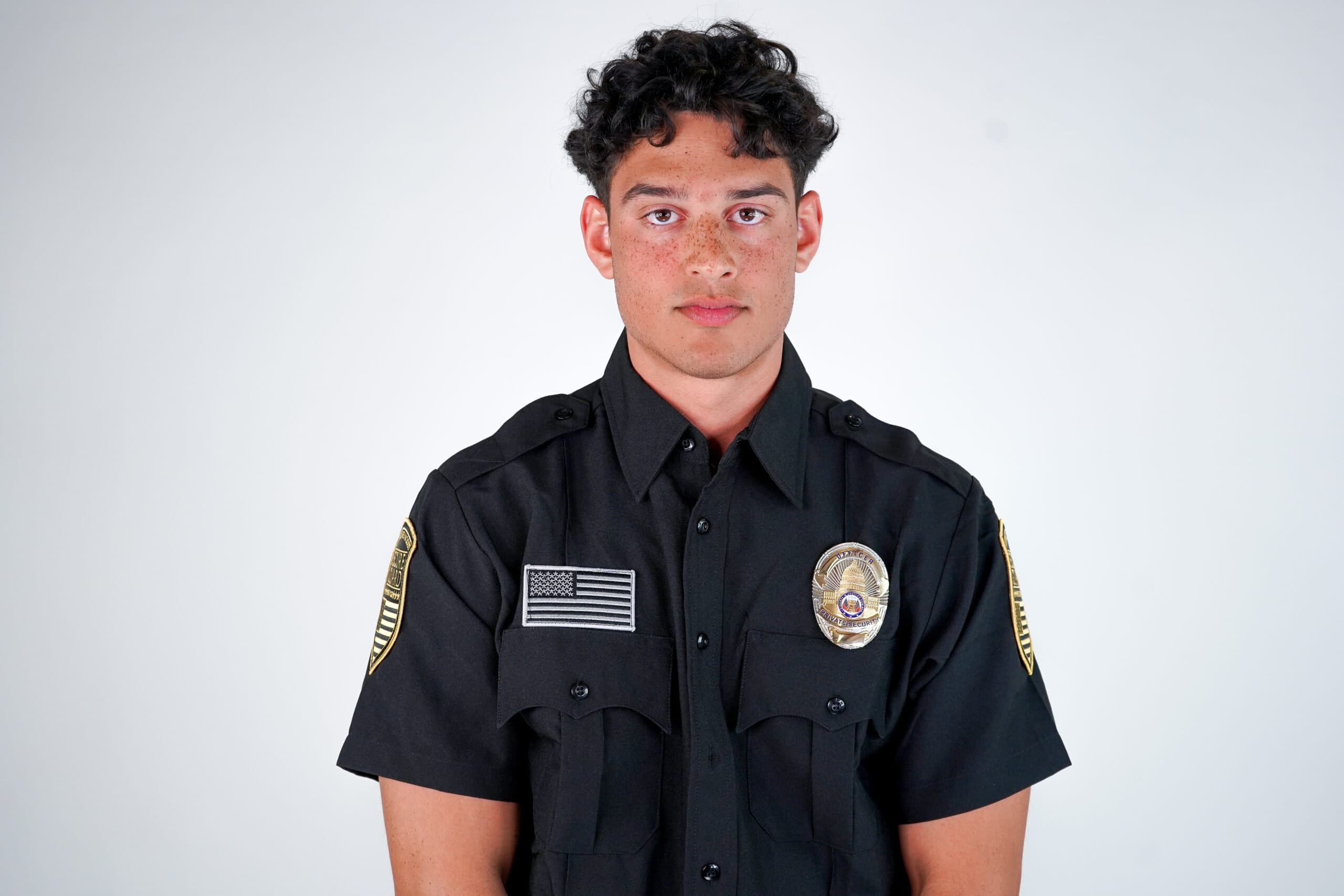 Professional security guard in uniform standing on duty, representing security guard services for protecting local businesses in Modesto
