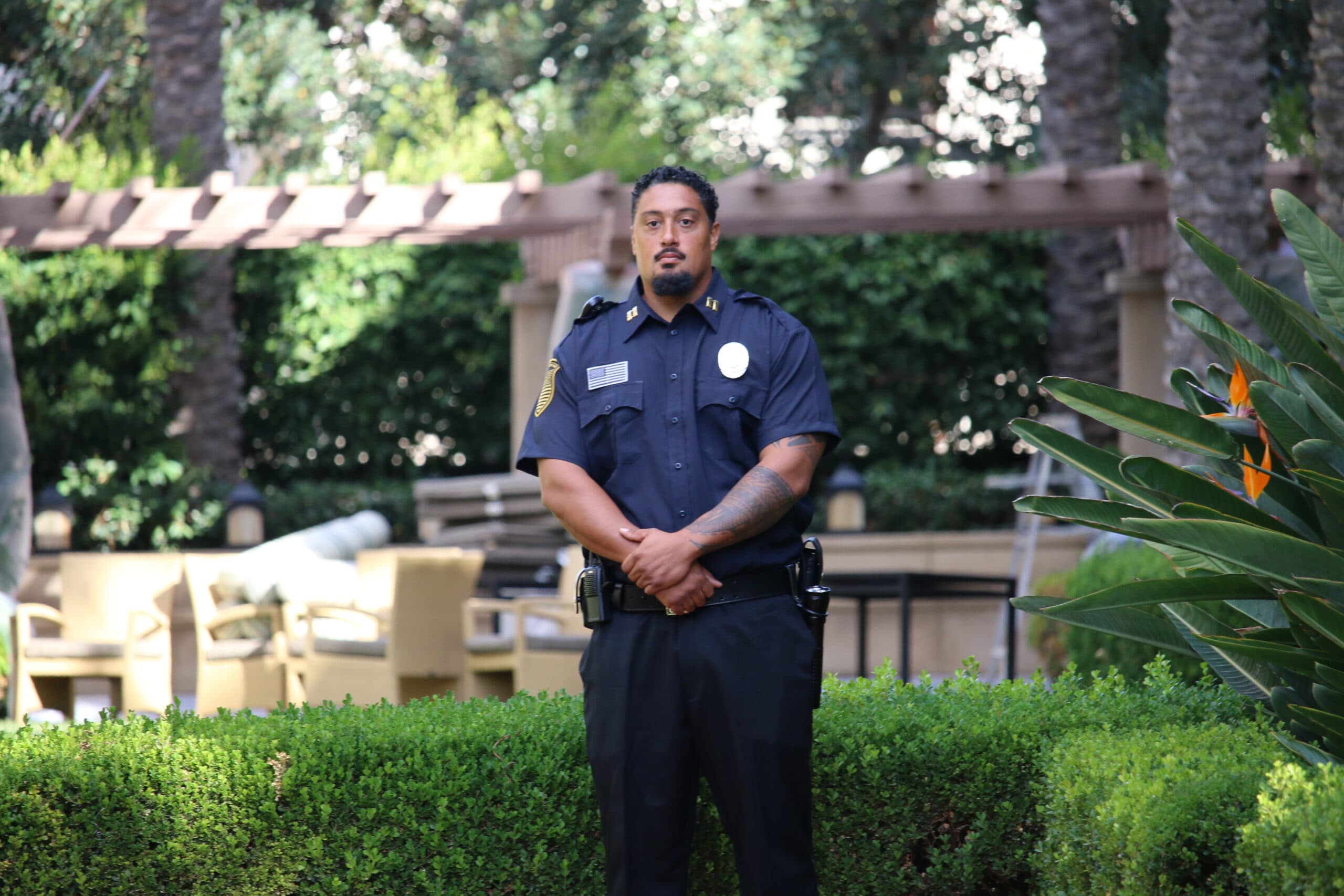 Professional security guard standing on patrol at a residential property, representing security guard services for property managers in San Jose